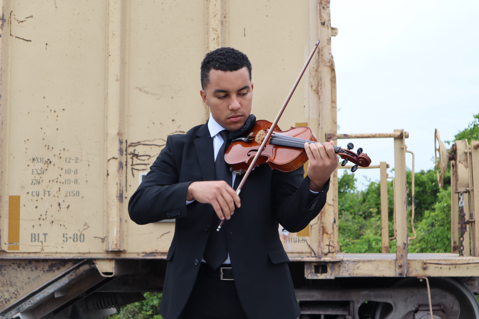Ian performing in a suit